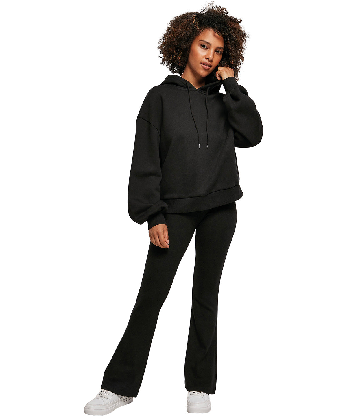 Build Your Brand Women's organic oversized hoodie in Black, lifestyle photo