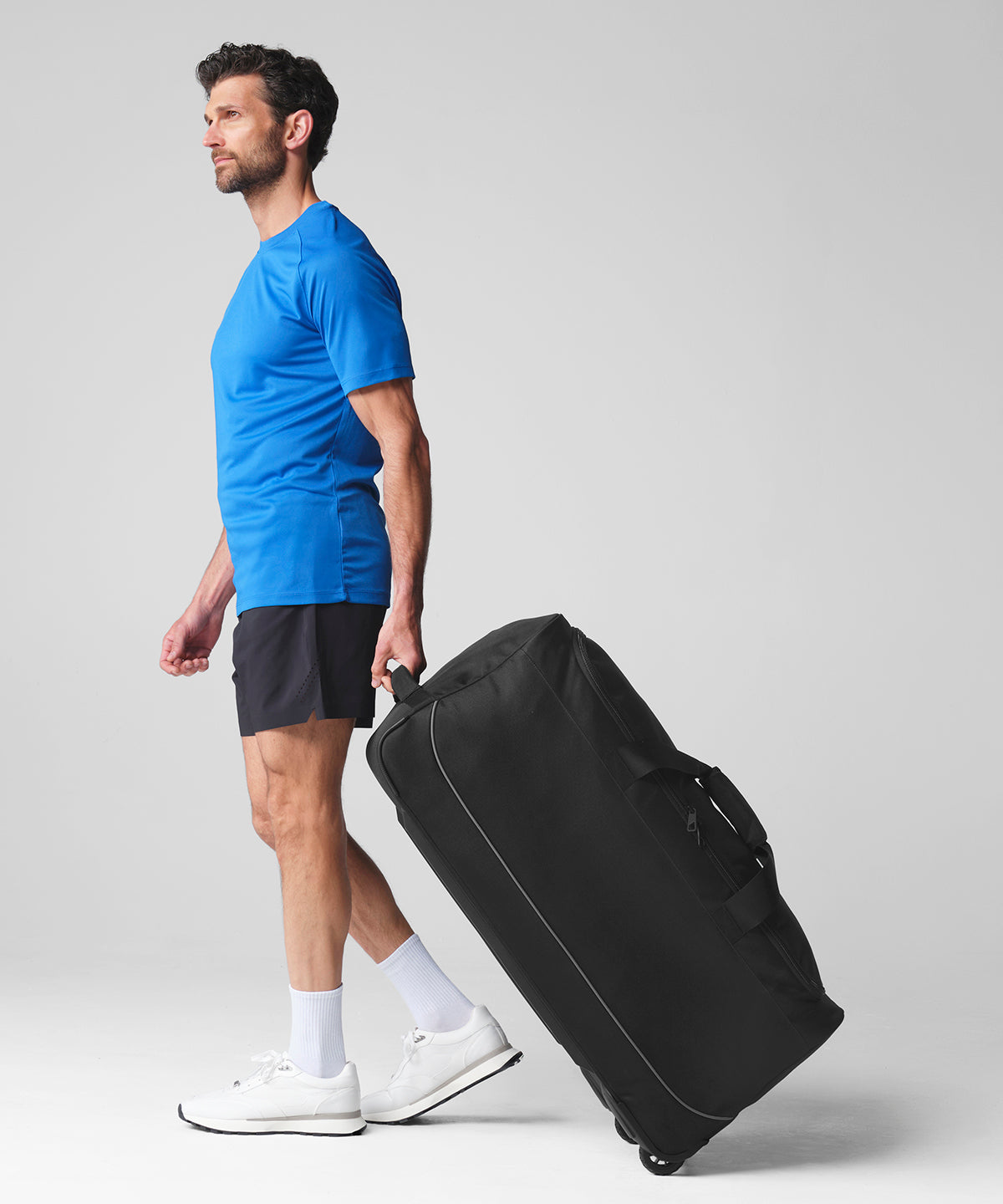 Quadra Teamwear wheeled holdall in Black/Grey, lifestyle photo