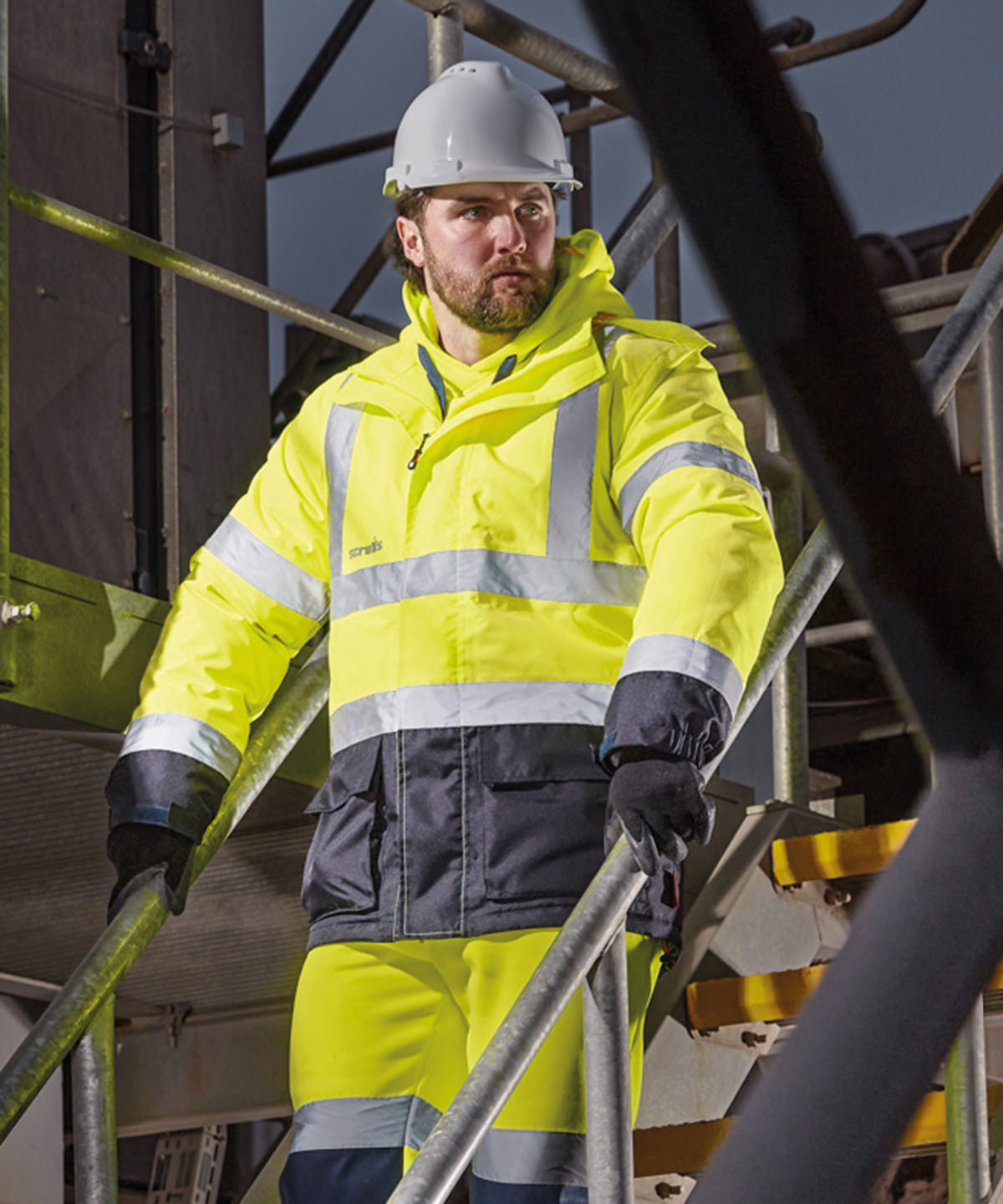 Scruffs High-visibility waterproof jacket in Yellow/Navy, lifestyle photo