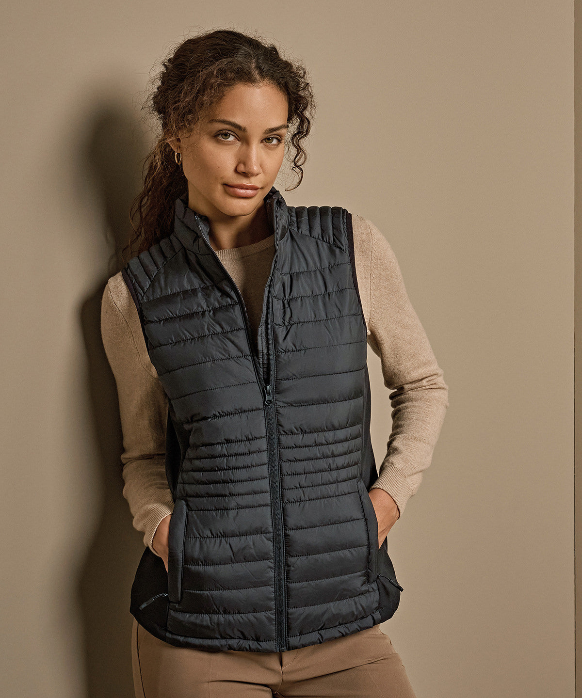 Tee Jays Women’s crossover bodywarmer in Black/Black/Black, lifestyle photo