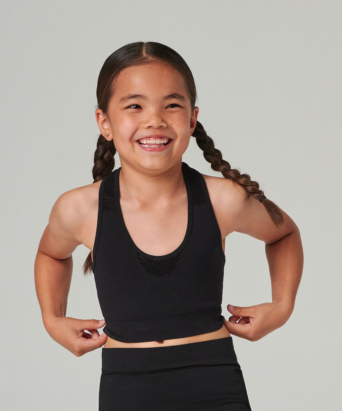 Tombo Kids seamless crop top in Black, lifestyle photo