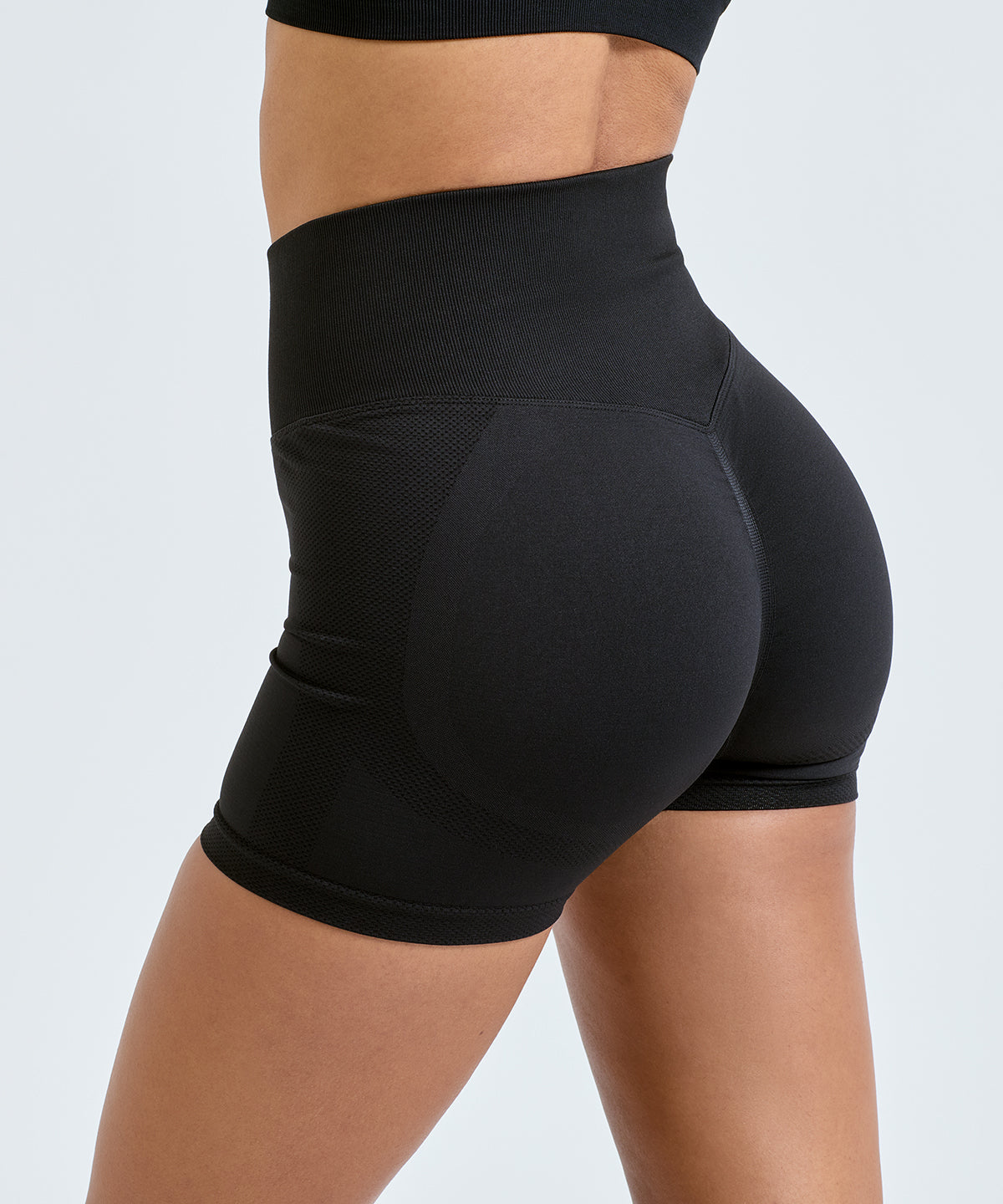 TriDri Women's recycled scrunch shorts in Black, lifestyle photo