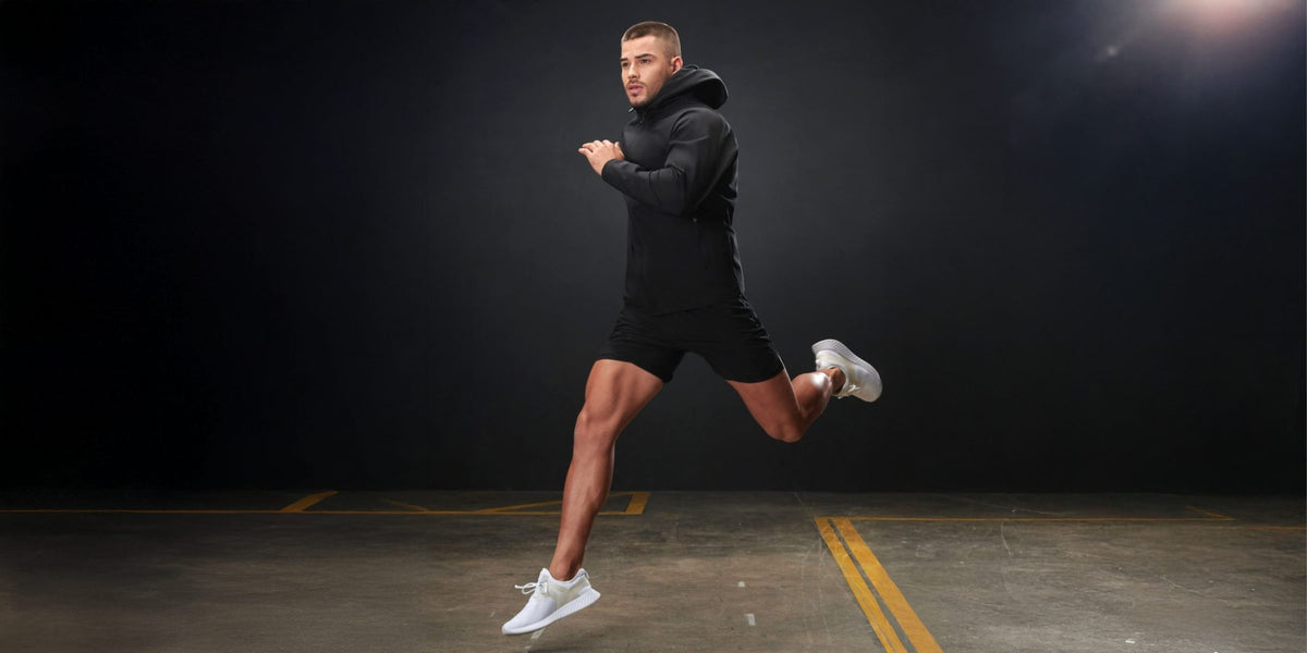 Runner in black Tombo activewear mid-stride